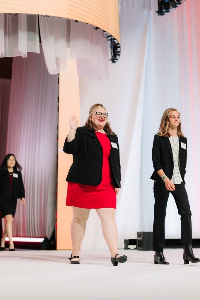 Ariona Cook walking and waving.