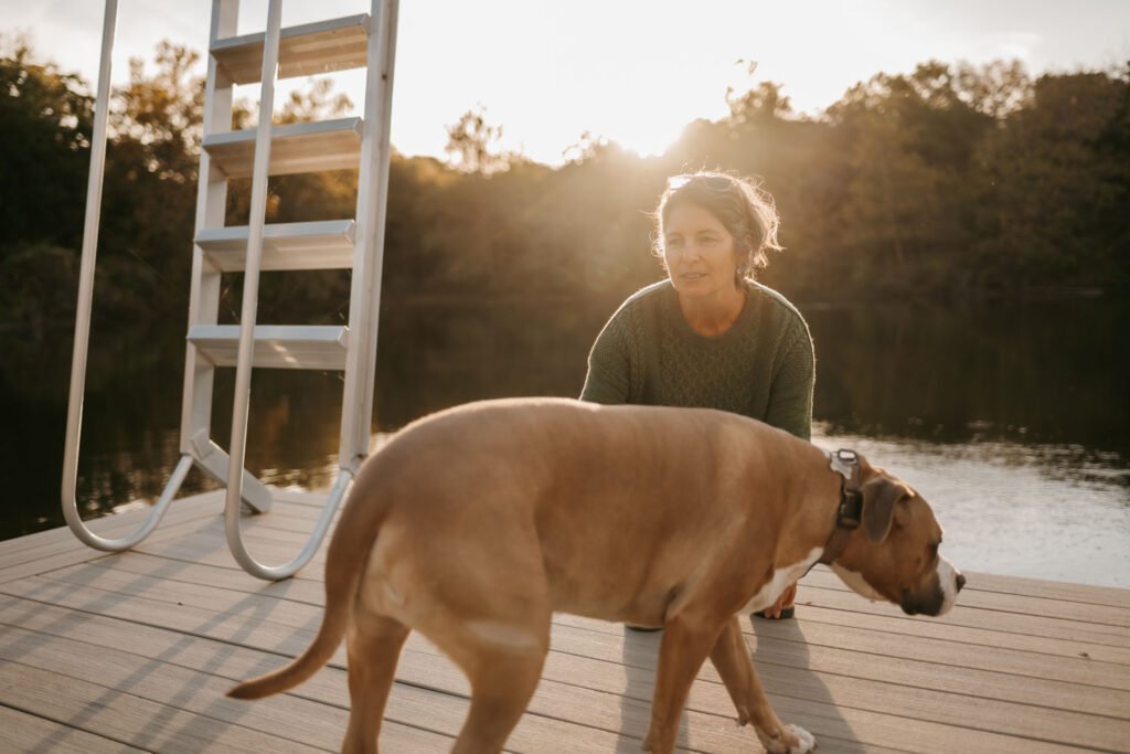 Sharon Autry with her dog on a dock.