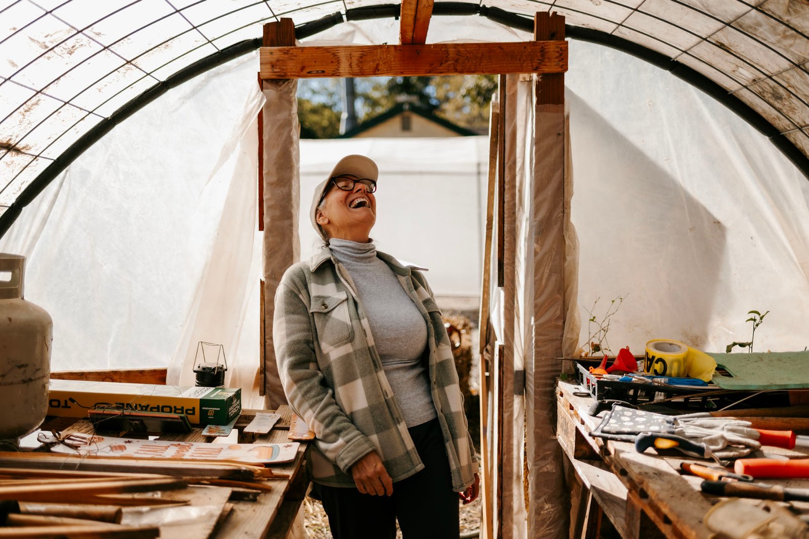 Lori Trojan laughing inside a workshop.