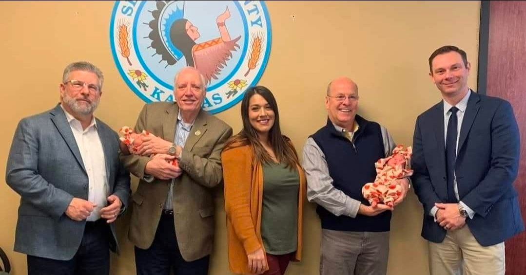 Sarah Lopez at Sedwick County office with coworkers and her twin babies.