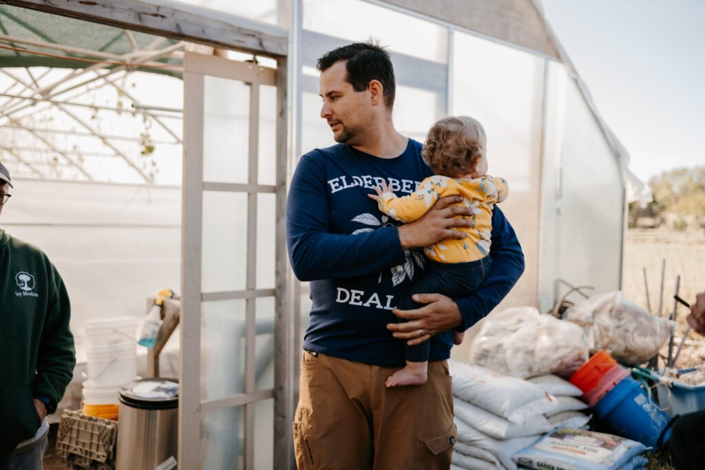 Mickey Gallagher holding his child